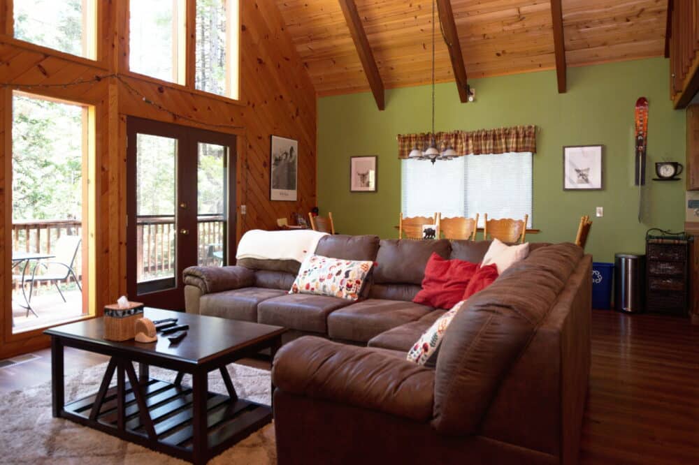 Dorrington Vacation Rental Cabins - Family-friendly living room with a brown couch and a coffee table.
