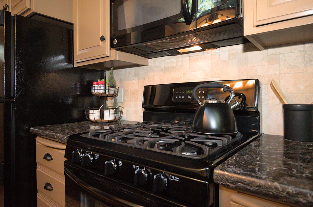Dorrington Vacation Rental Cabins - A cottage kitchen featuring a stove and microwave.