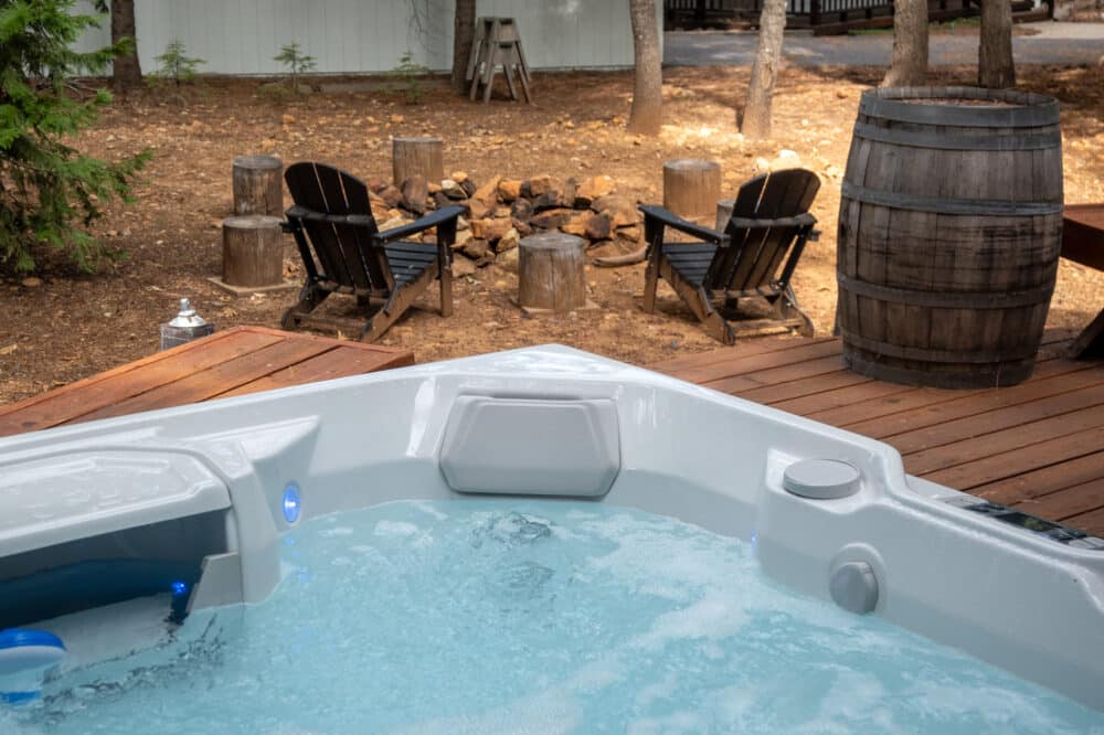 Dorrington Vacation Rental Cabins - Evergreen Cottage - A secluded hot tub in a wooded area.