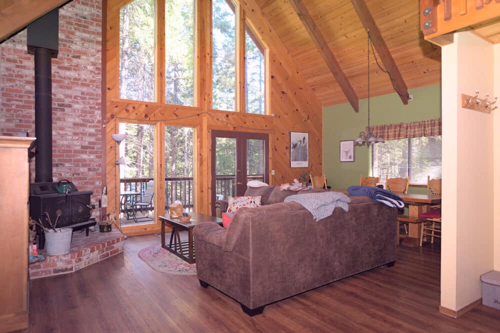 Dorrington Vacation Rental Cabins - Family-friendly living room with wood floors and a fireplace.